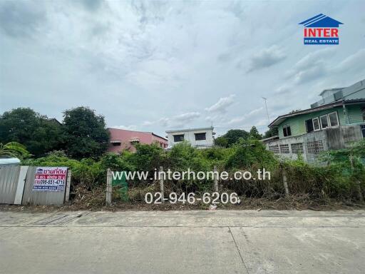 Front view of the property showing some greenery and neighboring houses