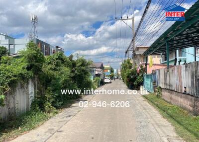 Street view of residential area with clear skies and telephone number displayed