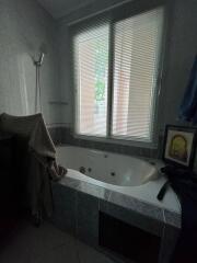 Bathroom with large bathtub and window