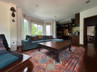 Spacious living room with large windows and vibrant decor