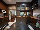 A well-equipped kitchen with dark cabinets and modern appliances