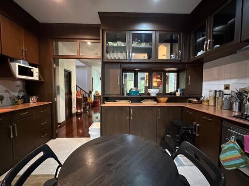 A well-equipped kitchen with dark cabinets and modern appliances