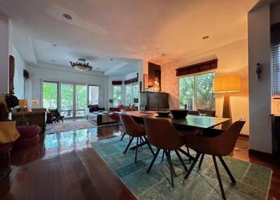 Spacious main living area with large windows, dining table, and seating area