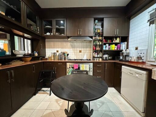 Modern kitchen with dark wood cabinetry and central round table