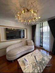 Contemporary living room with chandelier and marble coffee table