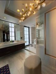 Modern bathroom with chandelier lighting and double sinks