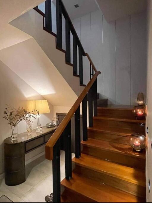 A well-lit staircase with wooden steps and decorative items