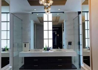 Modern bathroom with dual sinks and chandelier