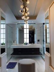 Modern bathroom with dual sinks and chandelier