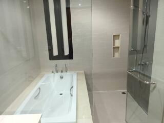 Modern bathroom with bathtub and glass shower