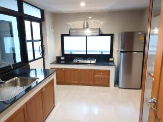 Modern kitchen with stainless steel appliances and wooden cabinets