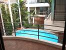 Balcony with a view of the pool and modern buildings