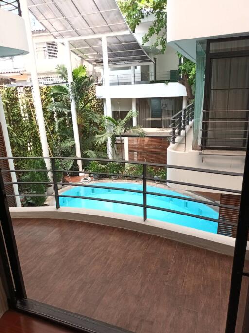 Balcony with a view of the pool and modern buildings