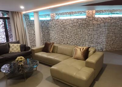 Spacious living room with stone accent wall