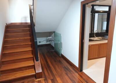 Staircase and hallway leading to the kitchen