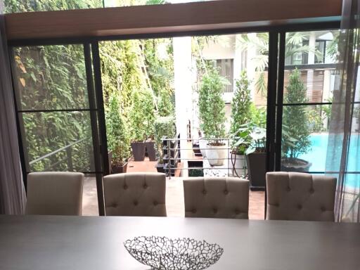 Dining area with pool and garden view