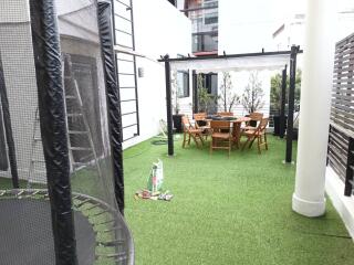 Outdoor area with dining setup and trampoline