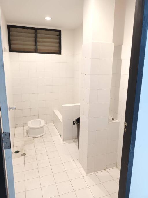 Bathroom with white tiles and toilet