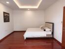 Simple and modern bedroom with wood flooring and minimalist decor