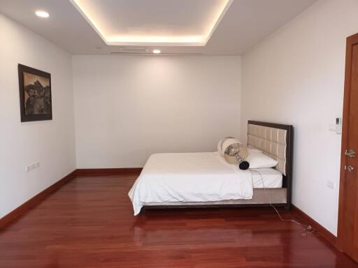 Simple and modern bedroom with wood flooring and minimalist decor