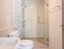 Modern bathroom with glass shower and patterned wall tiles