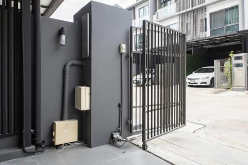 Modern building entry with gated parking