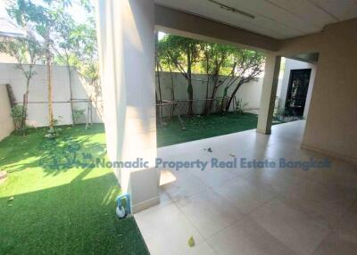 Covered patio with artificial grass yard