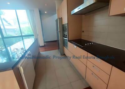 Modern kitchen with stainless steel appliances and large windows