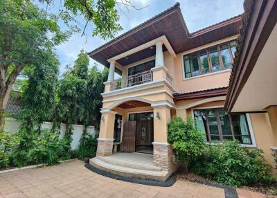 Two-story house with front yard and trees