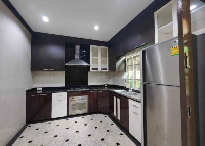 Modern kitchen with dark cabinetry and stainless steel appliances