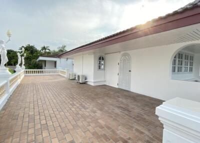 Outdoor terrace with white building and statues