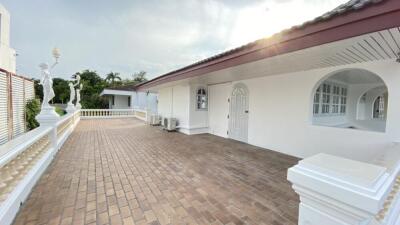 Outdoor terrace with white building and statues