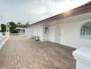 Outdoor terrace with white building and statues