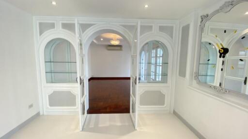 Elegant living area with arched glass doorways