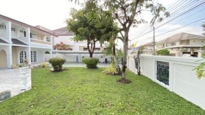 Spacious garden with trees and surrounding fence