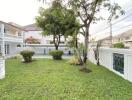 Spacious garden with trees and surrounding fence