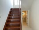 Staircase and view of a hallway with natural lighting.