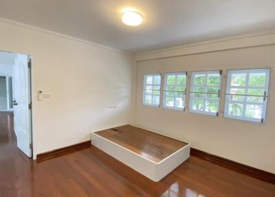 Bedroom with hardwood floors and large windows