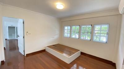 Bedroom with hardwood floors and large windows