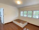 Bedroom with hardwood floors and large windows