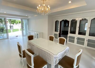 Elegant dining room with chandelier and garden view