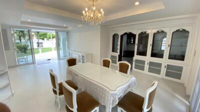 Elegant dining room with chandelier and garden view