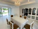 Elegant dining room with chandelier and garden view