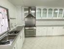 Modern white kitchen with stainless steel appliances