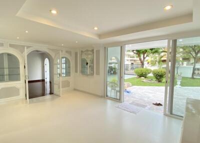 Spacious living room with large windows and garden view