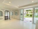 Spacious living room with large windows and garden view