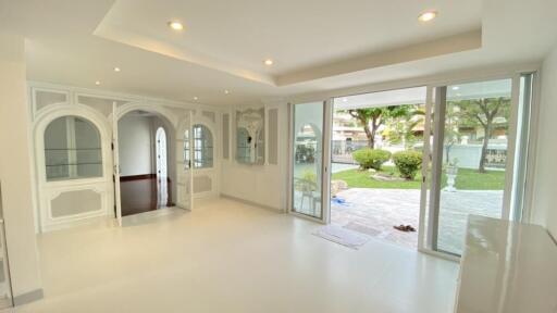 Spacious living room with large windows and garden view