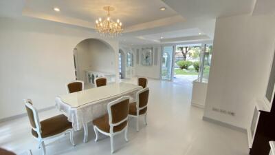 Elegant dining room with chandelier and garden view