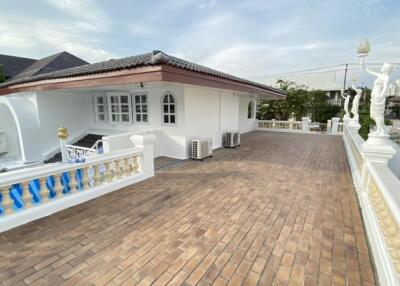 Spacious terrace with a building and statues