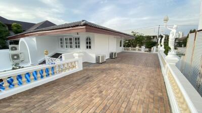 Spacious terrace with a building and statues